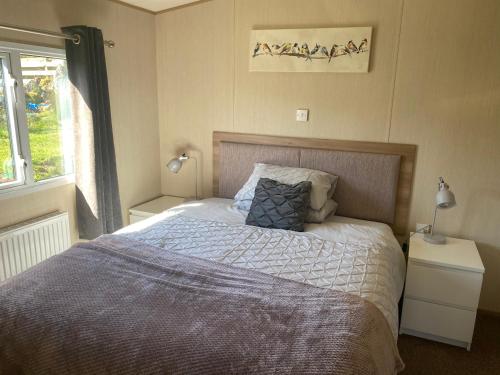 Heast的住宿－Summer Breeze，一间卧室设有一张大床和一个窗户。