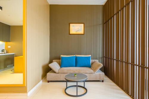 a living room with a couch and a table at Greystone 99 Suites in Melaka