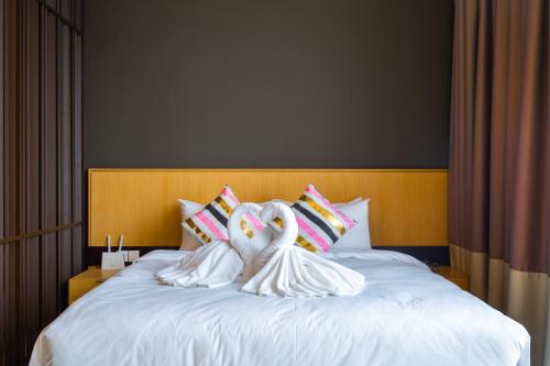 two swans made out of towels on a bed at Greystone 99 Suites in Melaka