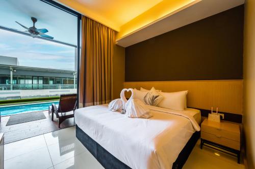 a bedroom with a large bed and a swimming pool at Greystone 99 Suites in Melaka