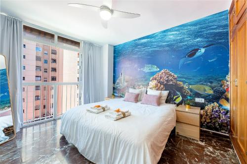 a bedroom with an aquarium on the wall at 797 HOLIDAY RENTALS - Atico duplex en Fuengirola con espectacular terraza in Fuengirola