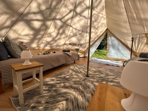 a bedroom in a yurt with a bed and a table at Sambla majutus in Hiiumaa