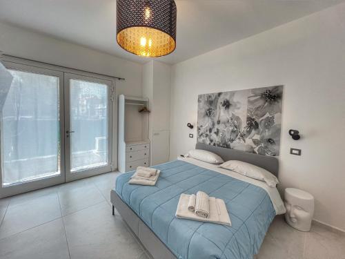 ein Schlafzimmer mit einem blauen Bett und einem großen Fenster in der Unterkunft A CASA DI MARIANNA in Ravenna