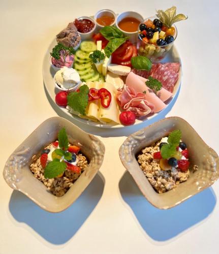 two plates of food with different types of food at Gästehaus Alpvital in Klais
