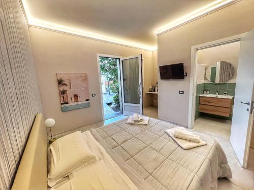 a large bedroom with a large bed and a bathroom at A CASA DI MARIANNA in Ravenna