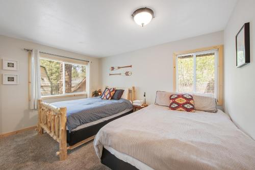 a bedroom with two beds and a window at Country Club Cabin in Big Bear City