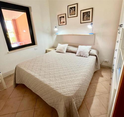 a bedroom with a bed in a room at 20 steps from the beach in Costa Rei