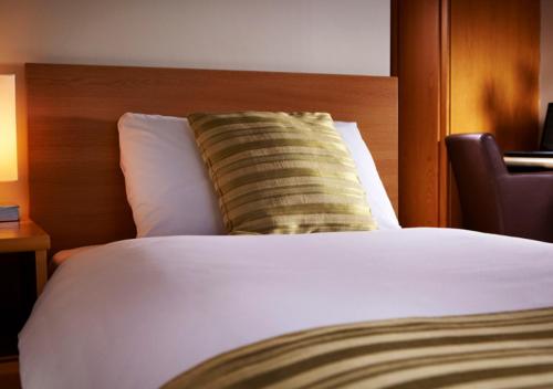 a bed with a pillow on top of it at Peter Scott House Birmingham in Birmingham