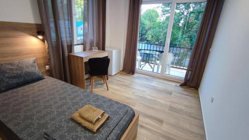 a bedroom with a bed and a view of a balcony at Villa Natali in Ohrid