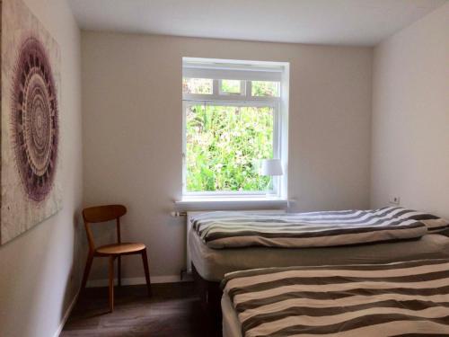 a bedroom with two beds and a window at Day Dream Kaupvangsstræti 19 in Akureyri