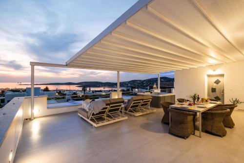 an outdoor deck with a view of the water at Panos Villa Sunset View in Parikia