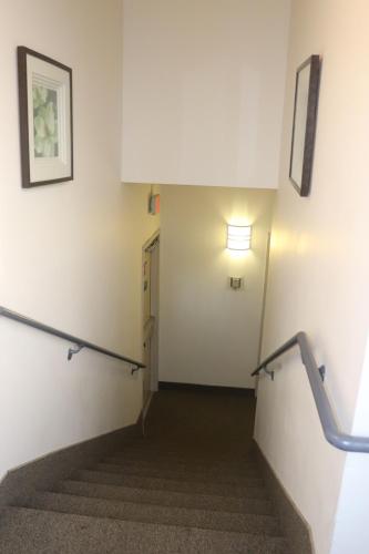 a hallway with stairs and a light on the wall at Howard Johnson by Wyndham Tifton GA I-75 in Tifton