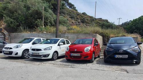 a group of three cars parked in a parking lot at Amphitrite in Myrties