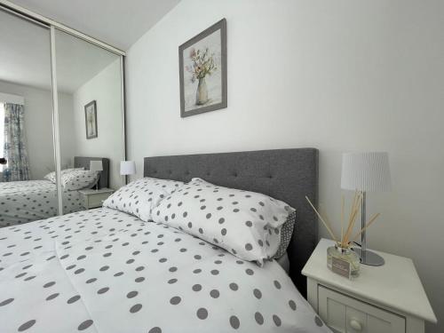 a bedroom with a bed with a large mirror at Quaint 2 Bed Village Retreat in Pevensey