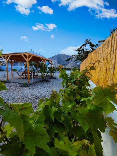 a pavilion and a picnic table on a beach at Oasis Apartments in Perissa