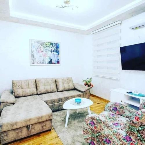 a living room with a couch and a table at ApartmentJakovNiksic in Nikšić
