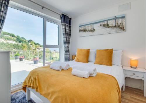 a bedroom with a large bed with towels on it at Villa 49 Millendreath Beach Resort in Saint Martin