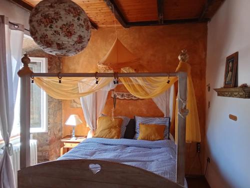 a bedroom with a bed with a canopy at Morelli House in Montalbo