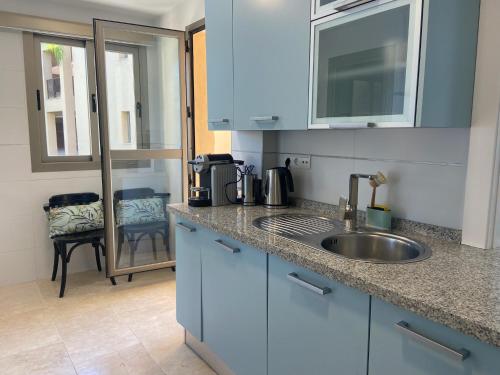 a kitchen with a sink and a counter top at Wonderful 3-bedroom apartment with garden and amazing views Hacienda Senorio Cifuentes Marbella in Benahavís