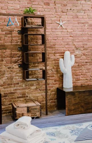 a room with a brick wall with a cactus on it at Ci Thorno Hotel in Crosia