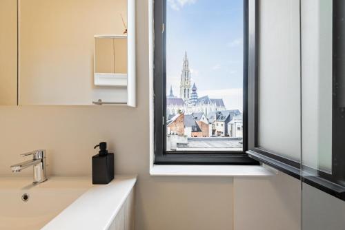 a bathroom with a window with a view of a city at Cozy Antwerp - Cityview Studio FREE PARKING in Antwerp