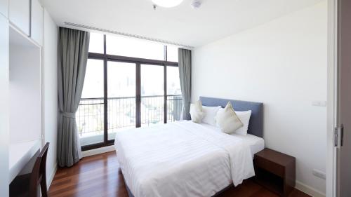 Rúm í herbergi á Citiresort Living sukhumvit 39