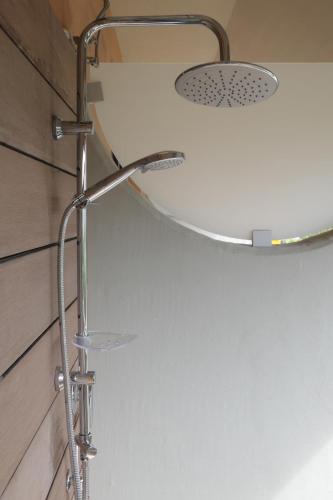 a shower in a bathroom with a shower head at Pausa Mare Seaside in Torre a Mare