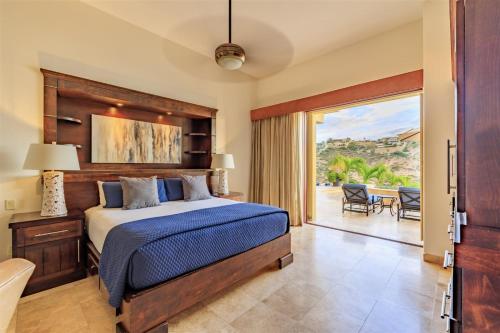 a bedroom with a bed and a view of a patio at Casa Bella in San José del Cabo