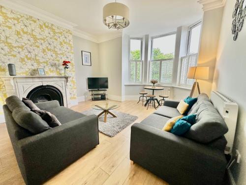 a living room with two couches and a fireplace at Moorgate View - Free on street Parking in York