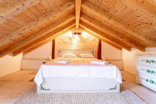 a bedroom with a white bed in a attic at Holiday house with a swimming pool - Villa Melavita in Stari Grad