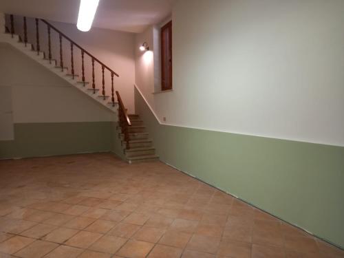 an empty room with stairs and a tiled floor at Antica fonte in Montefranco
