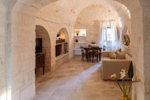 a living room with a stone archway and a table at I trulli di Kate in Monopoli