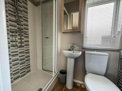 a bathroom with a toilet and a sink and a shower at Wonderful 6 Berth Caravan For Hire By A Stunning Norfolk Beach Ref 19006sd in Scratby