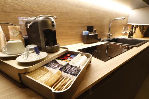 a kitchen with a sink and a coffee maker at Giargeri Home in Misterbianco