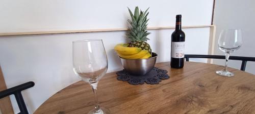 a table with a bottle of wine and two wine glasses at Rooms Diana in Split