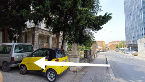 a small car parked on the side of a street at Rooms Diana in Split