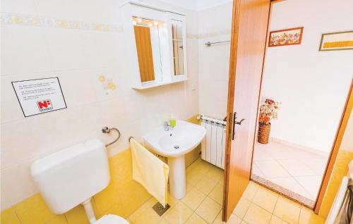 a bathroom with a sink and a toilet and a shower at 2 Bedroom Lovely Apartment In Labin in Labin