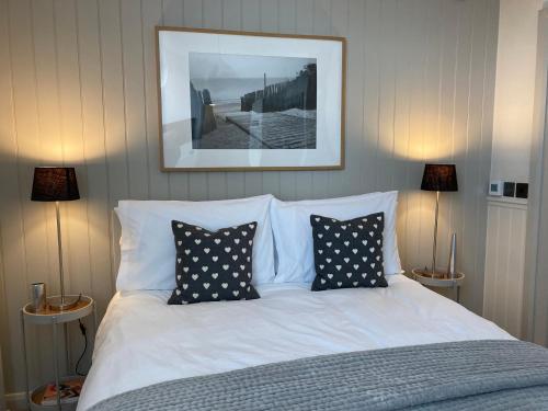 a bedroom with a white bed with pillows at The Old Bell B&B in Grimston