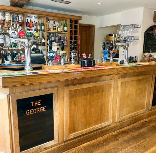 a bar with a sign that reads the greeppe at The George in Bridgnorth