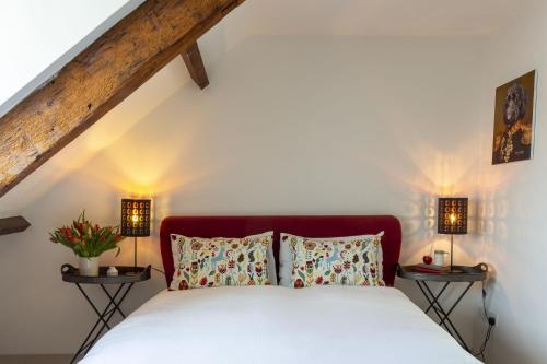 a bedroom with a white bed with two lamps at Start Way in Kingsbridge
