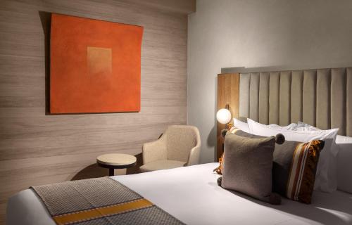 a hotel room with a bed and a chair at NUMU Boutique Hotel, The Unbound Collection by Hyatt in San Miguel de Allende
