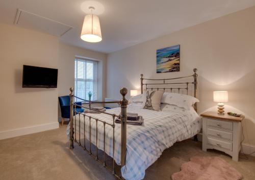 a bedroom with a bed and a television in it at Wilmer House in Hawes