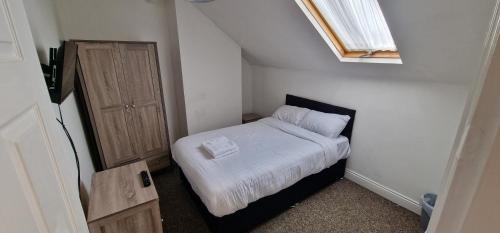 a small bedroom with a bed and a window at APARTMENT in CENTRAL DONCASTER in Doncaster
