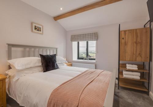 a bedroom with a large bed and a window at Mary End in Hawes