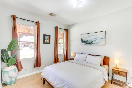 a white bedroom with a bed and a window at Arizona Desert Vacation Rental with Pool Access! in Eloy