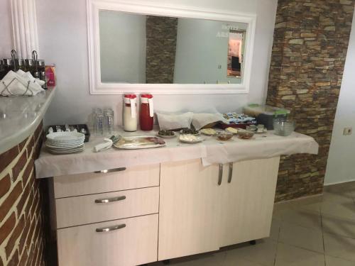 a kitchen with a counter with food on it at Hotel Arsenal in Ksamil