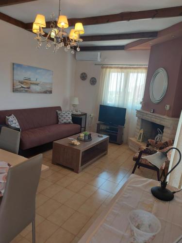 a living room with a couch and a table at Meliti Villa in Argostoli