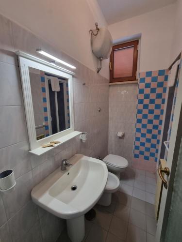 a bathroom with a sink and a toilet at Hotel Portofina in Santa Marinella