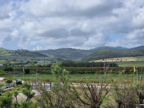 a view of a field with mountains in the background at Hotel Portofina in Santa Marinella