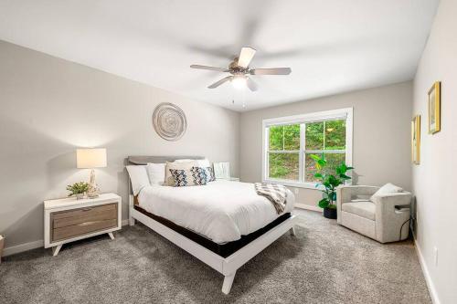 een slaapkamer met een bed, een plafondventilator en een stoel bij High-end on a budget at Truist Park in Atlanta